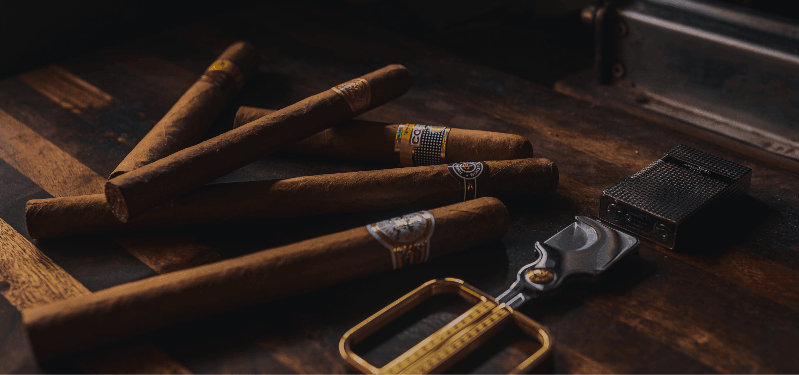 A still life of cigars and collector boxes